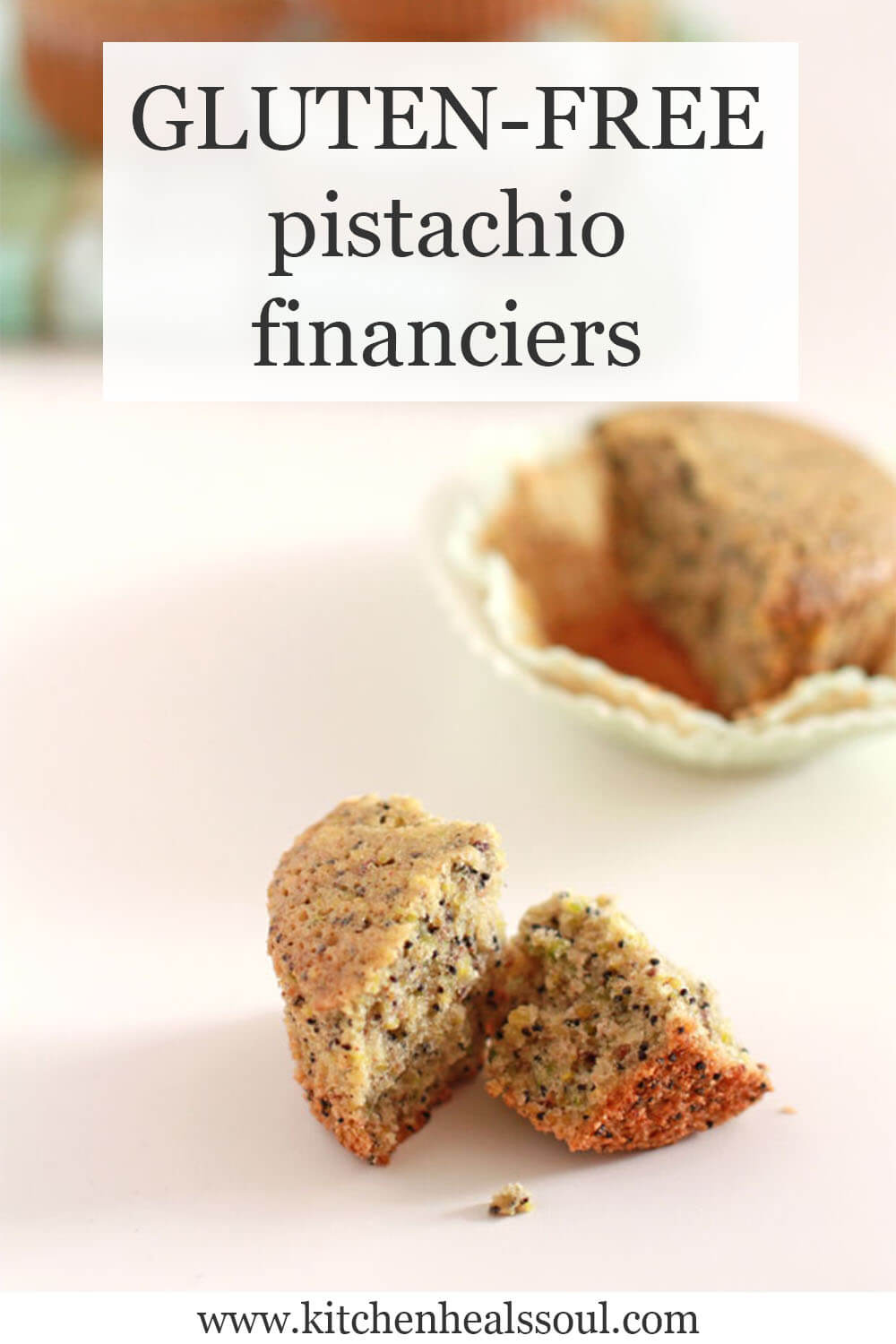 Financiers cakes, one broken open to show the crumb laced with black poppy seeds