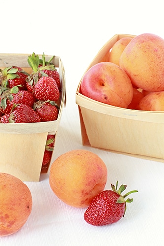 Baskets of strawberries and apricots