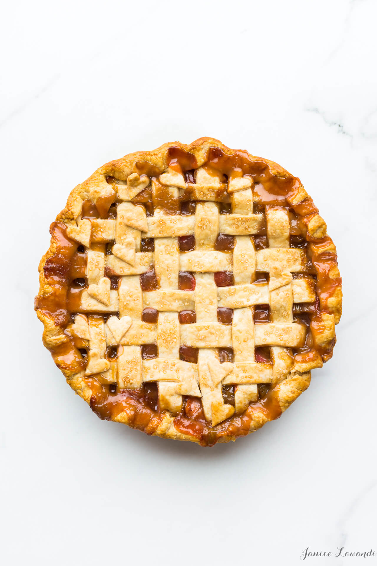Homemade rhubarb pie with a lattice pie crust and heart cutouts